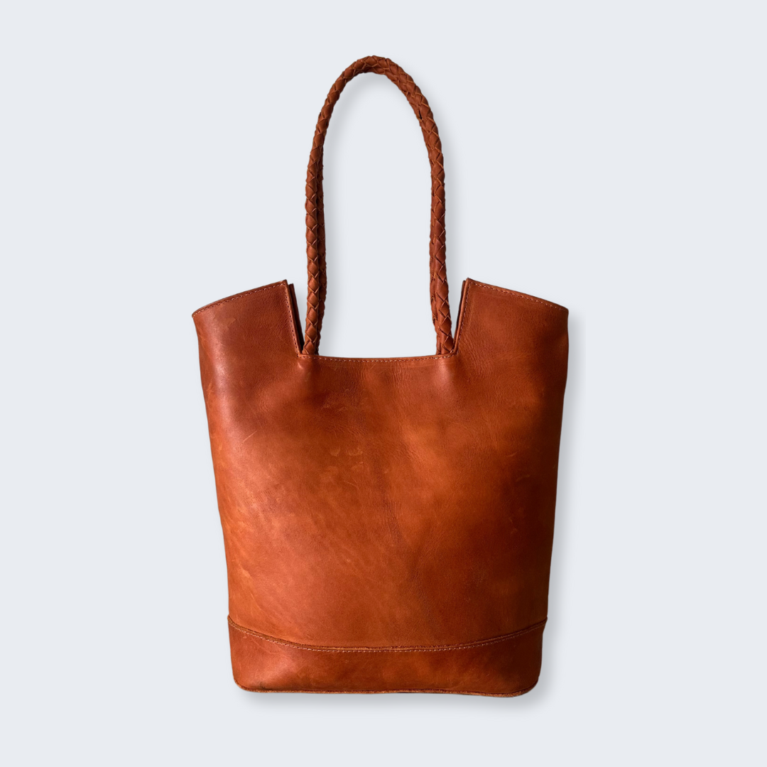 Back view of full-grain leather tote handcrafted in Guatemala with braided strap