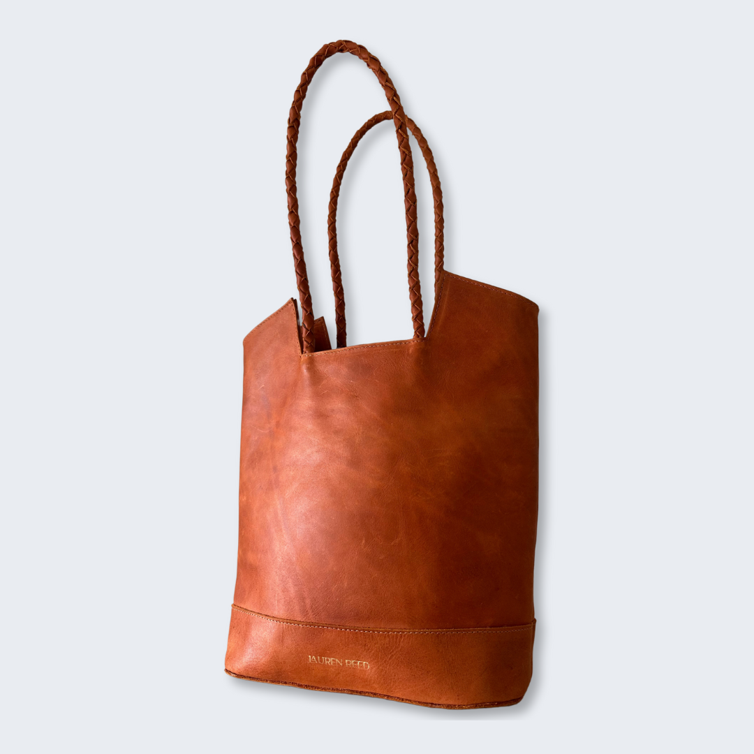 Angled view of leather tote with braided strap and tonal texture, Lauren Reed Co.