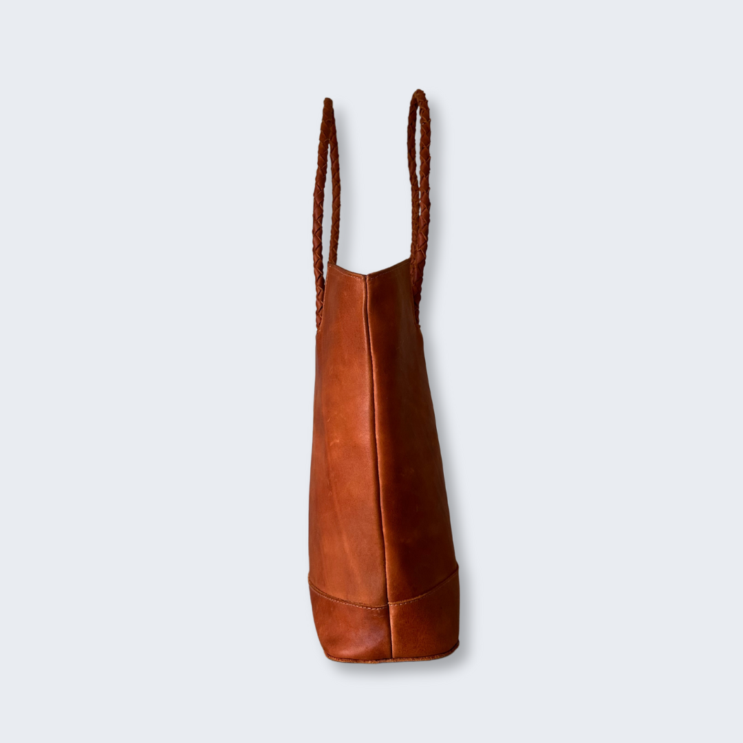 Side profile of artisan leather tote bag with hand-stitched details, made in Guatemala